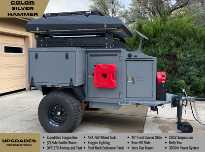 A gray off-road camping trailer WARHOSE OVERLAND shown parked outdoors on a driveway, with a black 2-tower rack rack and roof top tent, red fuel containers, and a hitch. Text overlays describe features and upgrades.